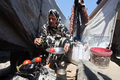 In Gaza's tent camps, a cigarette lighter becomes a lifeline