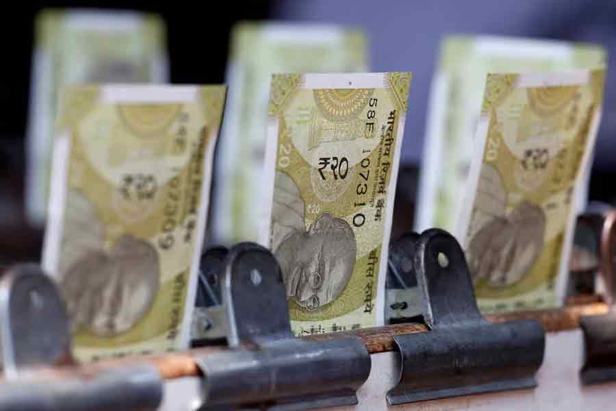 Rupee slumps on strong demand to buy dollars at daily fix, weak yuan