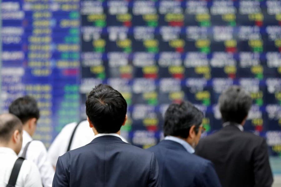 Asian shares shrug off Wall Street weakness, dollar steadies