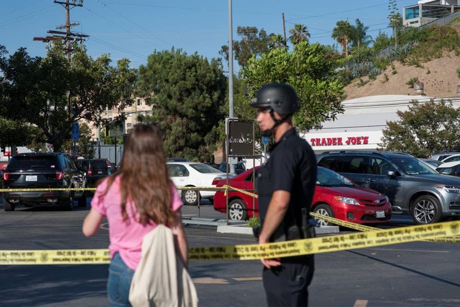 Woman dies in US store shooting; suspect in custody