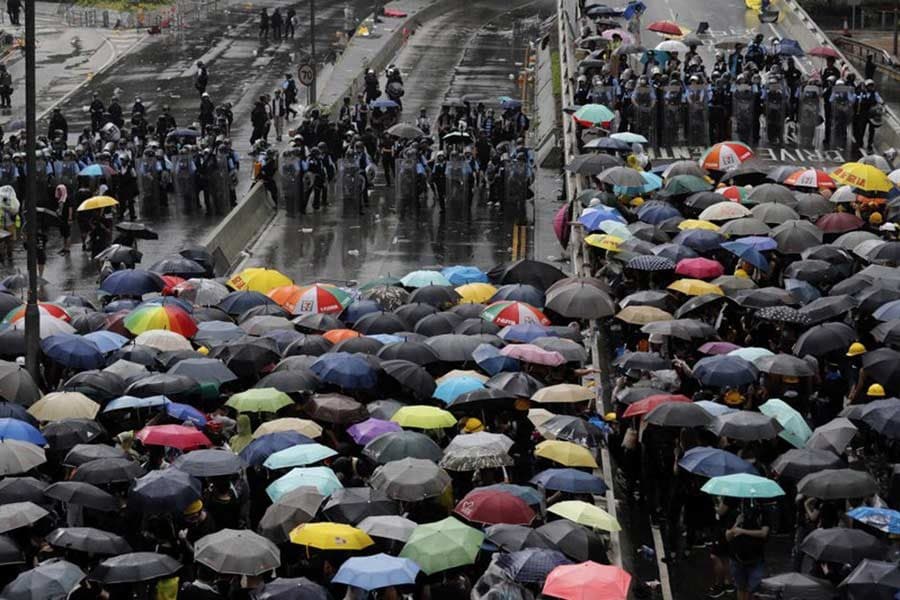 Protests escalate in Hong Kong as thousands rally to mark handover