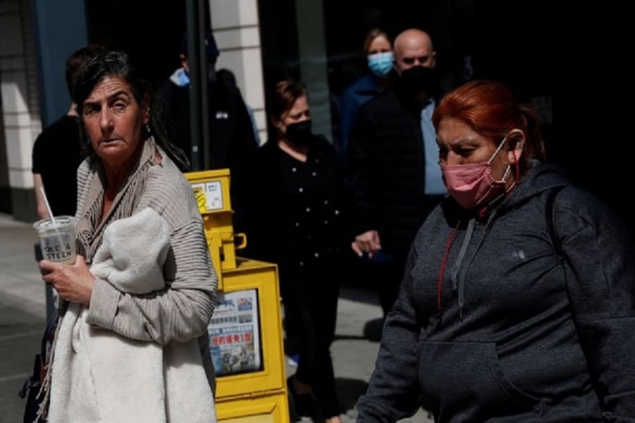 Some Americans hesitate to shed masks despite eased outdoor rules